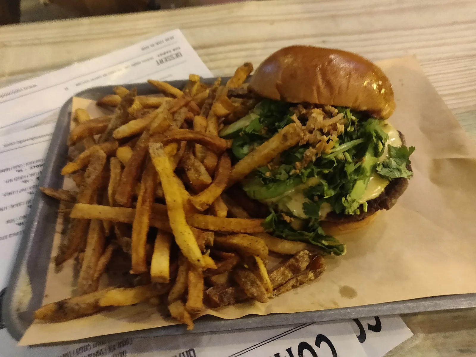 A cheeseburger and fries on a plate. The photo was not taken in High Point.